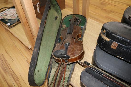 Three half size violins, a quantity of bows and six violin cases